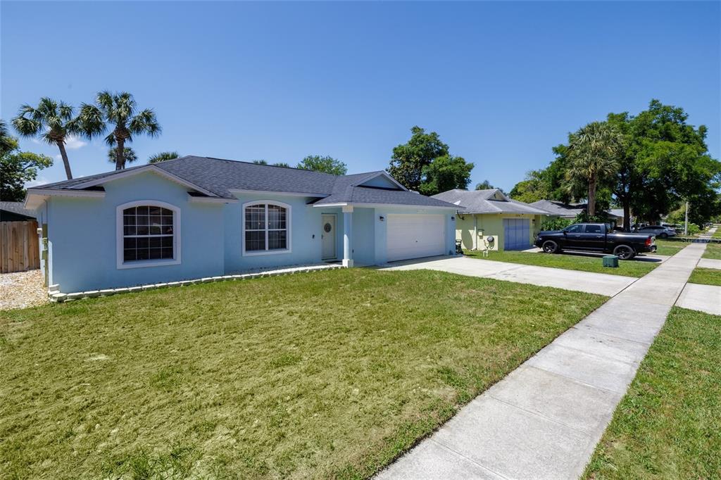 A light blue single-story house with a dark roof and a concrete driveway — 2980 WINDLE LANE, SOUTH DAYTONA, FL