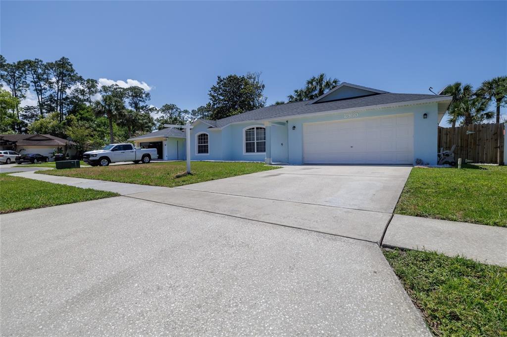 A light blue single-story house with a two-car garage and a concrete driveway — 2980 WINDLE LANE, SOUTH DAYTONA, FL