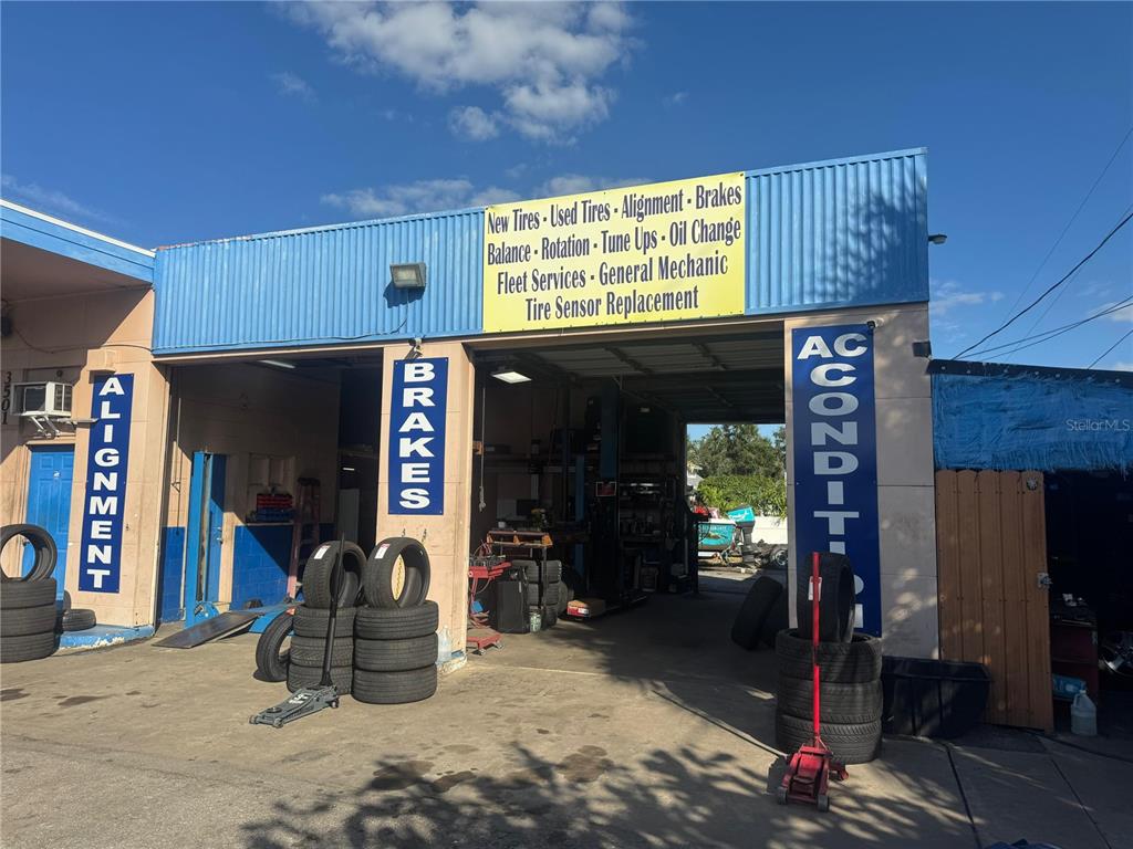 The exterior of a commercial auto repair shop features multiple service bays and signage — 3501 14TH STREET W, BRADENTON, FL
