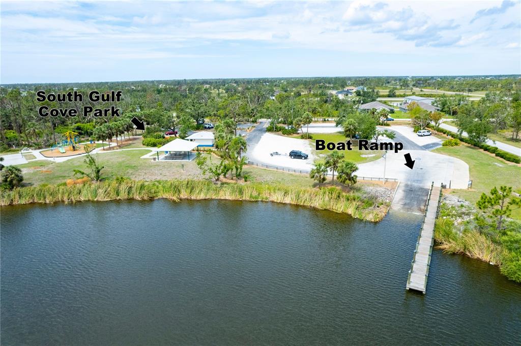 An aerial view shows a park with a playground, picnic shelter, and boat ramp — 15068 INGRAHAM BOULEVARD, PORT CHARLOTTE, FL