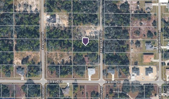 This aerial map shows a vacant residential lot marked with a purple pin — 1805 JEFFERSON AVENUE, LEHIGH ACRES, FL