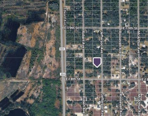 This is an aerial map view showing a vacant lot marked with a purple pin — 1805 JEFFERSON AVENUE, LEHIGH ACRES, FL