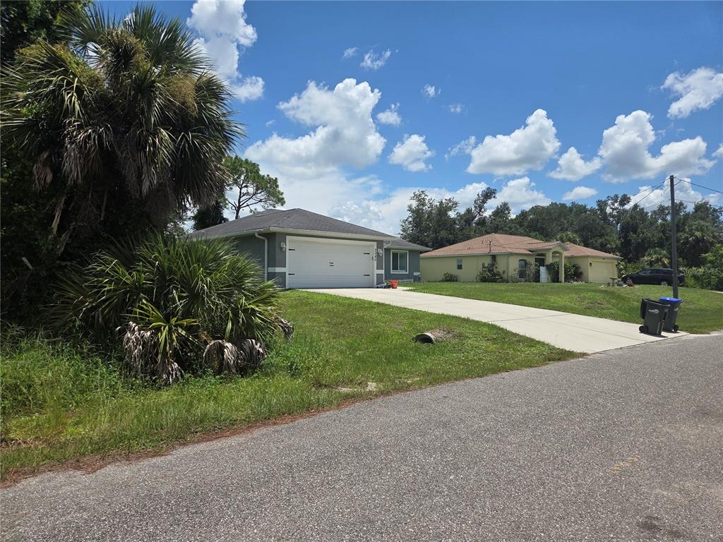 A gray single-story house with a two-car garage and a concrete driveway — SELOVER ROAD, NORTH PORT, FL