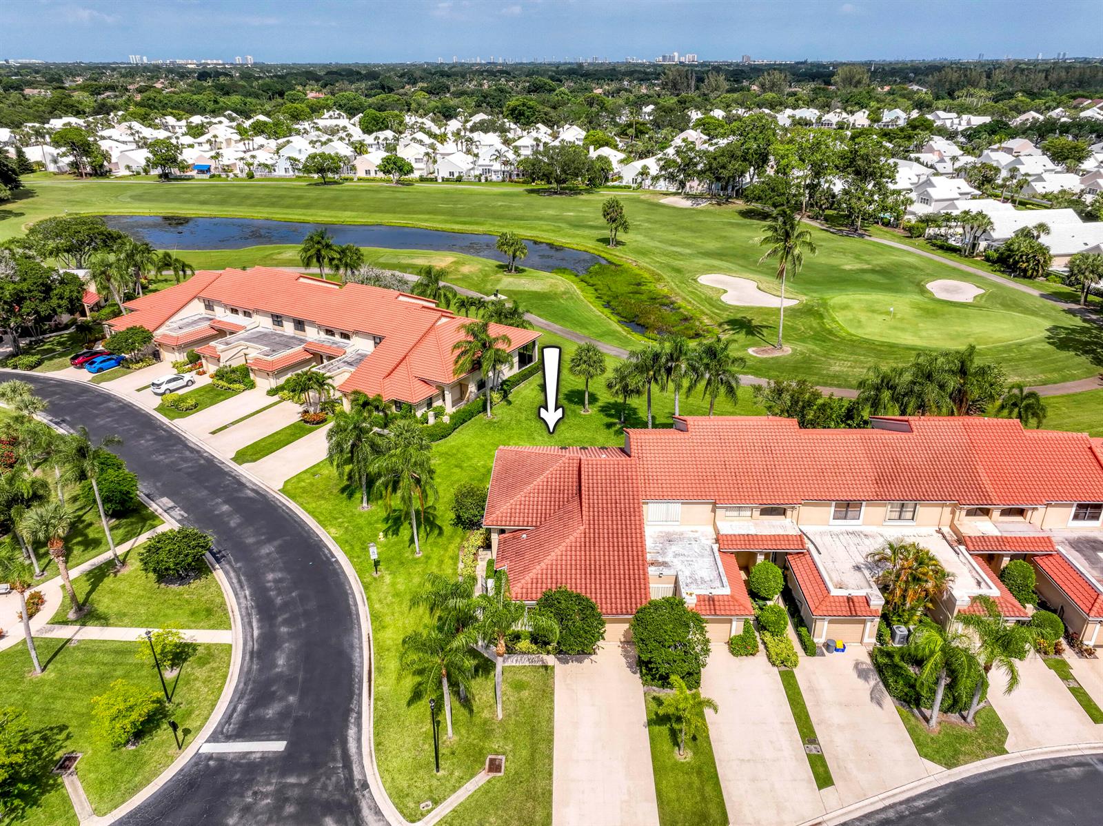 An aerial view shows two multi-unit residential buildings with red tile roofs near a golf course — 850 Windermere Way, Palm Beach Gardens FL 33418, PALM BEACH GARDENS, FL