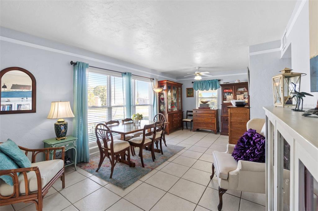 A dining room features tile floors, a wooden table with chairs, and two wooden hutches — 3197 NORMANDY DRIVE, PORT CHARLOTTE, FL