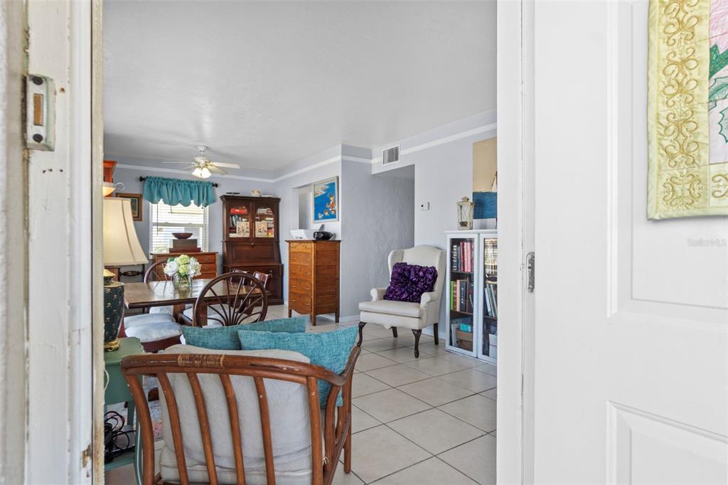 A view through a doorway into a dining and living area with tile flooring — 3197 NORMANDY DRIVE, PORT CHARLOTTE, FL