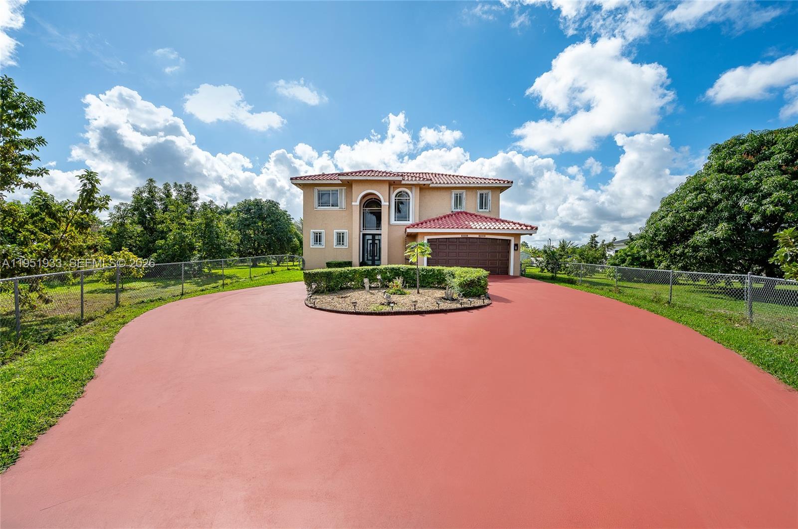 A two-story house with a red tile roof and a large circular driveway — 19520 SW 206th St, Miami FL 33187, MIAMI, FL