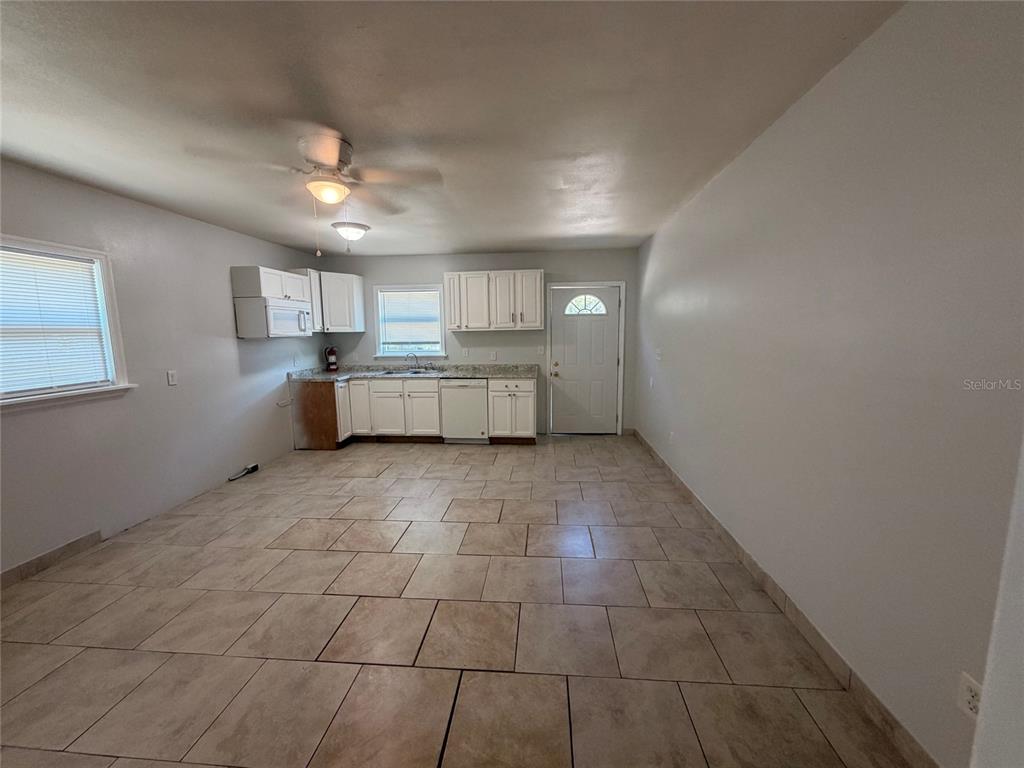 A kitchen with white cabinets, light tile flooring, and a ceiling fan — 110 FOREST AVENUE UNIT 8, DAVENPORT, FL