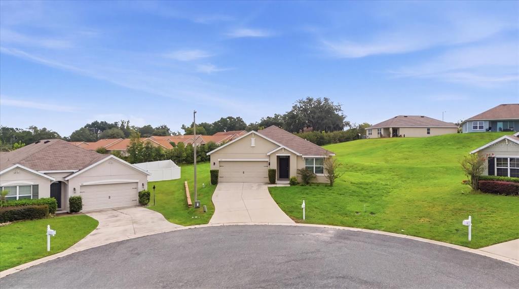 A suburban street view showing two single-story houses with driveways and grassy lawns — 3592 N BURROUGHS PATH, BEVERLY HILLS, FL