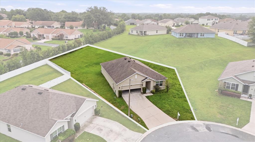 An aerial view shows a single-story house with a driveway on a grassy lot — 3592 N BURROUGHS PATH, BEVERLY HILLS, FL