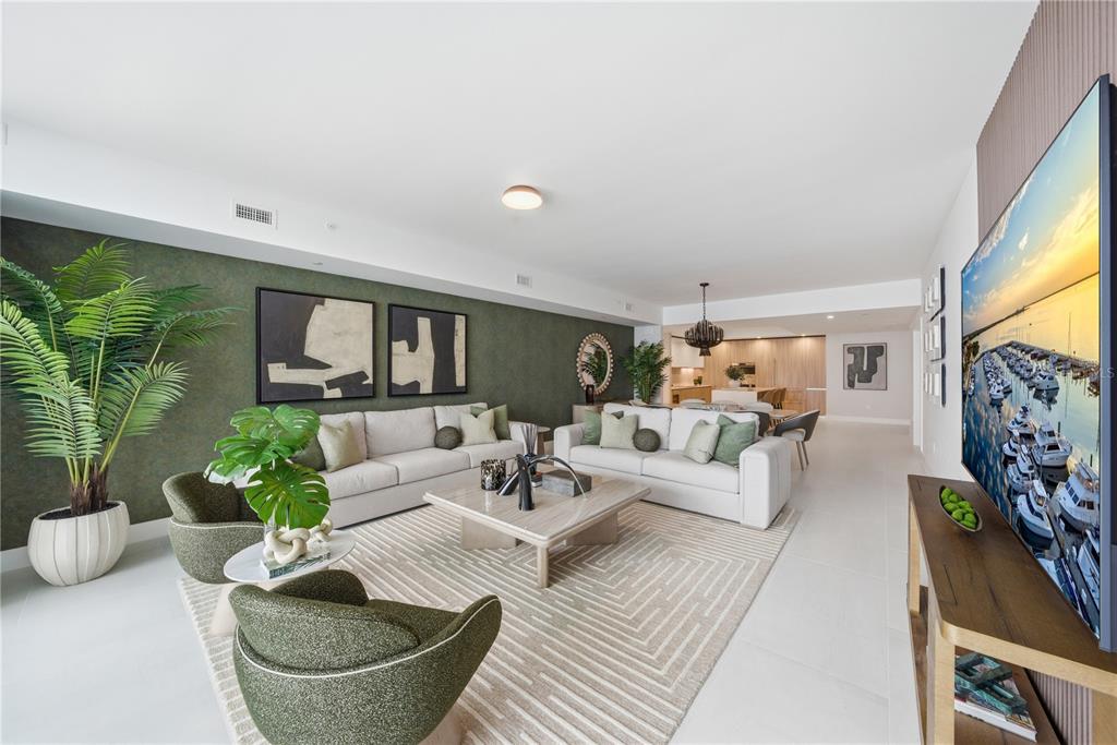 A modern kitchen features light wood cabinetry, white countertops, a central island, and integrated appliances — 5713 BOWEN DANIEL DRIVE UNIT 1002, TAMPA, FL