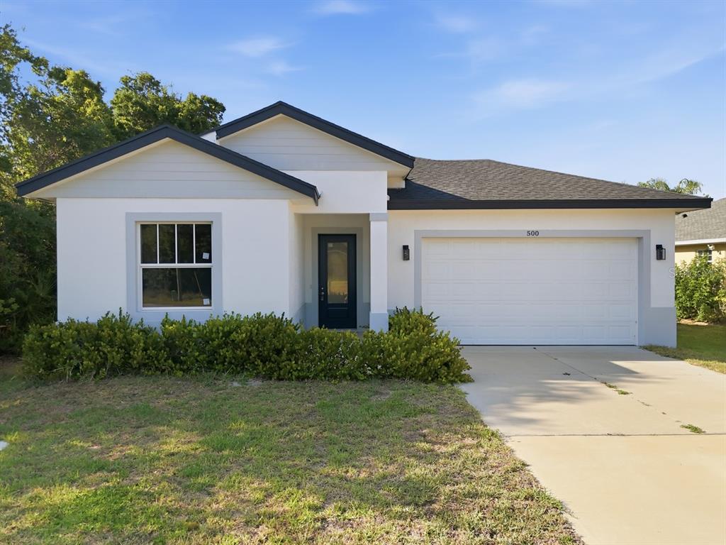 A modern kitchen features black cabinets, white countertops, a central island, and stainless steel appliances — 500 SUNSET ROAD N, ROTONDA WEST, FL