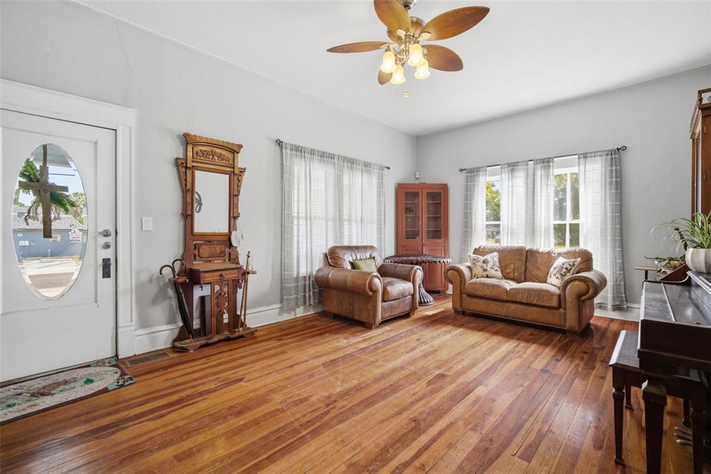 A living room features hardwood floors, a ceiling fan, leather furniture, and a front door — 1201 W REYNOLDS STREET, PLANT CITY, FL