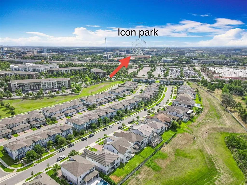 An aerial view shows a suburban residential neighborhood with a distant view of Icon Park — 7398 ALPINE BUTTERFLY LN, ORLANDO, FL