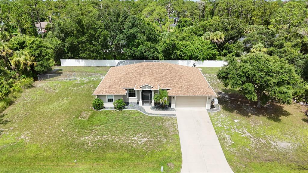 An aerial view of a single-story house with a tan roof and attached garage — 2613 TRIANNA STREET, NORTH PORT, FL