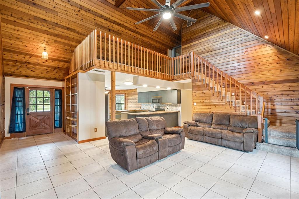 An aerial view shows a house with a driveway, large yard, and trees — 25911 ABERDOVEY AVENUE, SORRENTO, FL