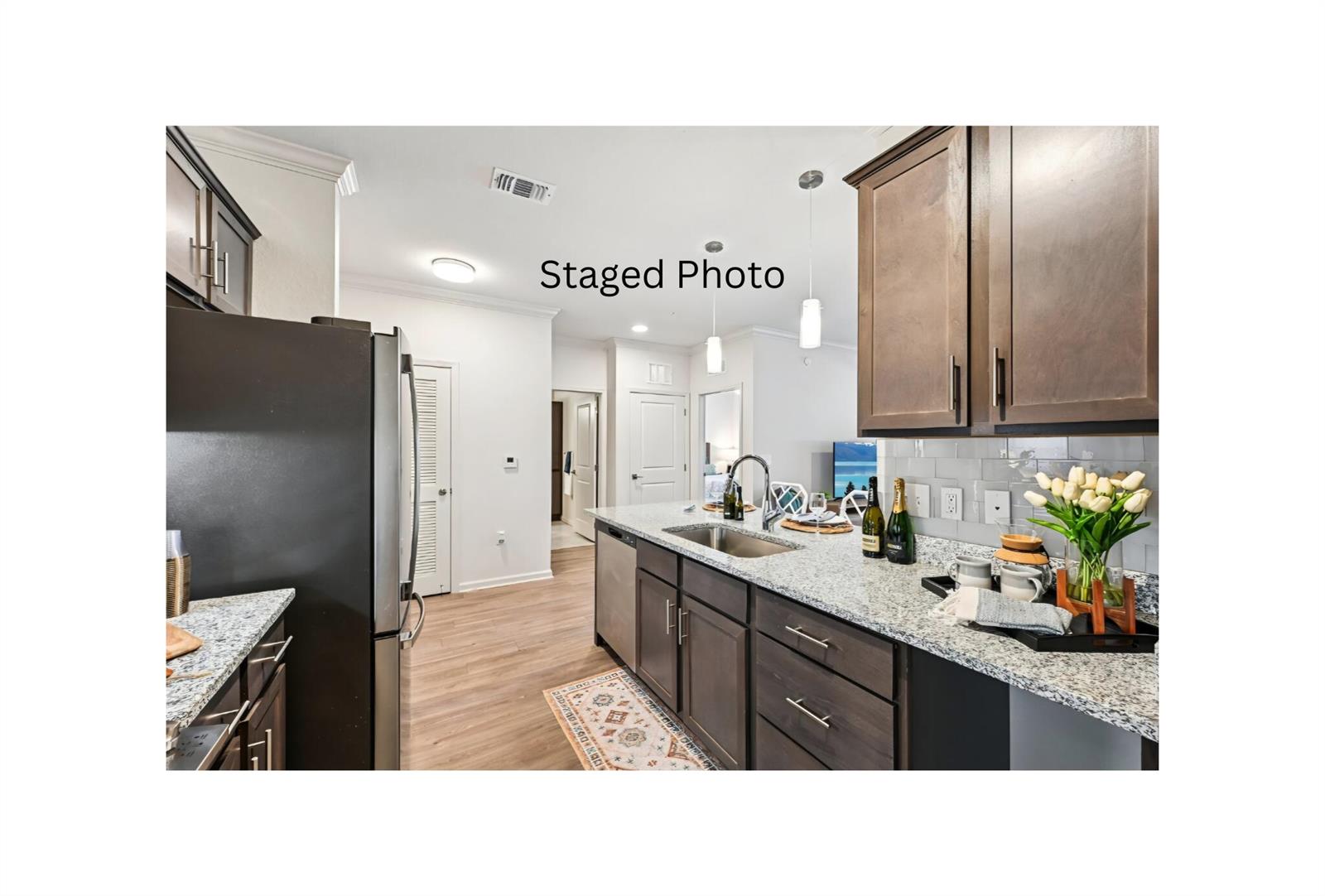 A kitchen features dark wood cabinets, granite countertops, stainless steel appliances, and a central island — 1900 NW Federal Highway, Stuart FL 34994, STUART, FL