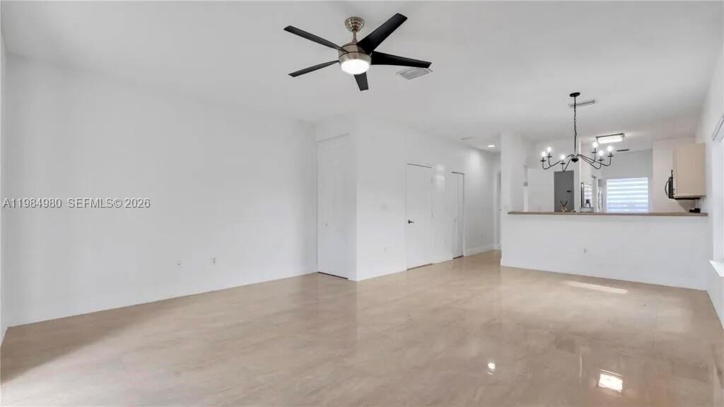 An open-concept living area features white walls, a ceiling fan, and light-colored tile flooring — 4921 SW 140th Ter # 1, Miramar FL 33027, MIRAMAR, FL