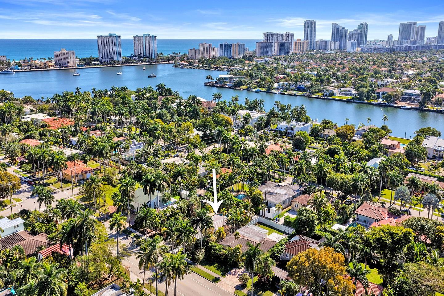 An aerial view of a residential neighborhood with a white arrow pointing to a house — 1016 Harrison St, Hollywood FL 33019, HOLLYWOOD, FL