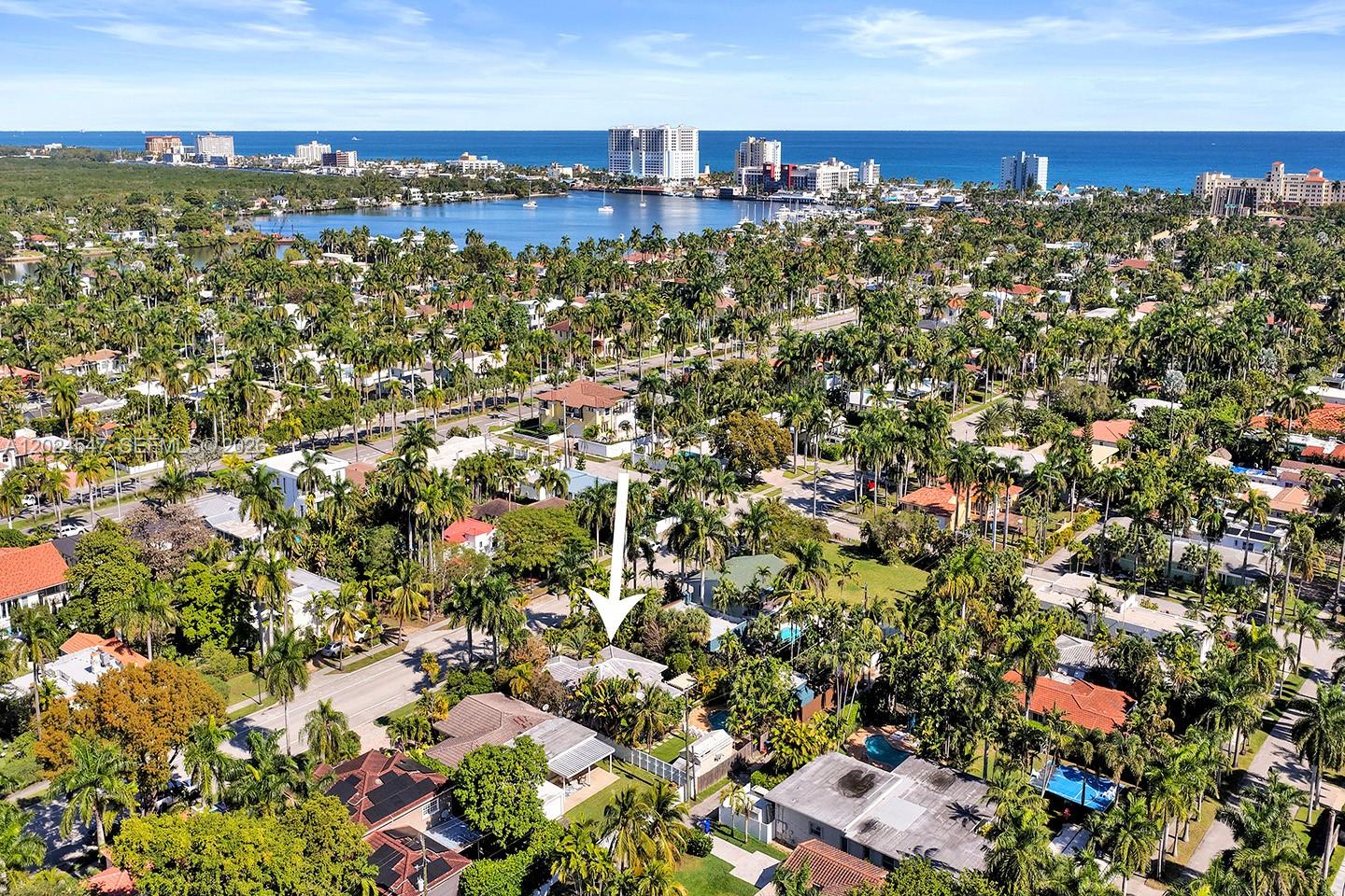 An aerial view shows a residential neighborhood with a white arrow pointing to a house — 1016 Harrison St, Hollywood FL 33019, HOLLYWOOD, FL