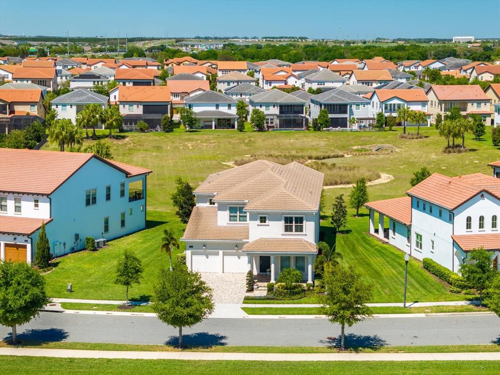An aerial view shows a two-story suburban house with a tiled roof and green lawn — 8222 TOPSAIL PLACE, WINTER GARDEN, FL