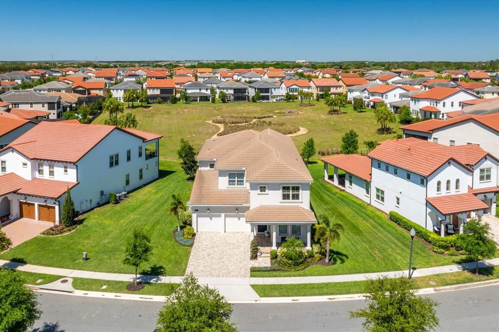 An aerial view shows a two-story suburban house with a tiled roof and paved driveway — 8222 TOPSAIL PLACE, WINTER GARDEN, FL