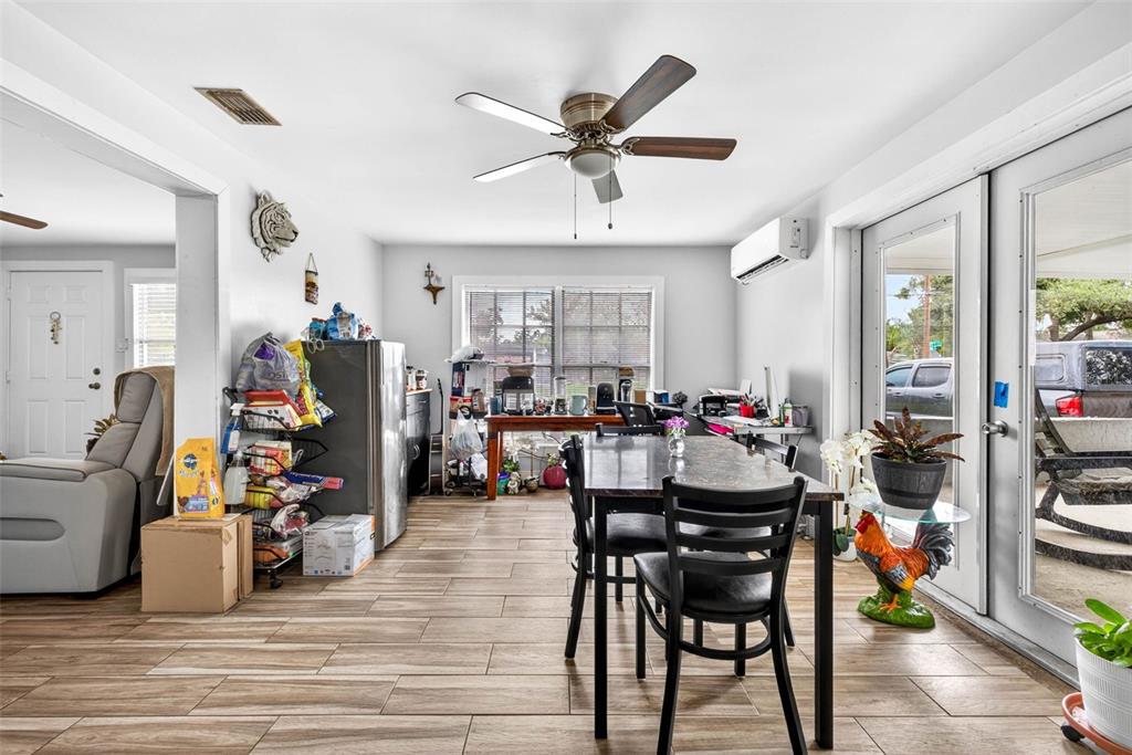 A dining area features tile flooring, a ceiling fan, and a glass door to the exterior — 5008 N 17TH STREET, TAMPA, FL