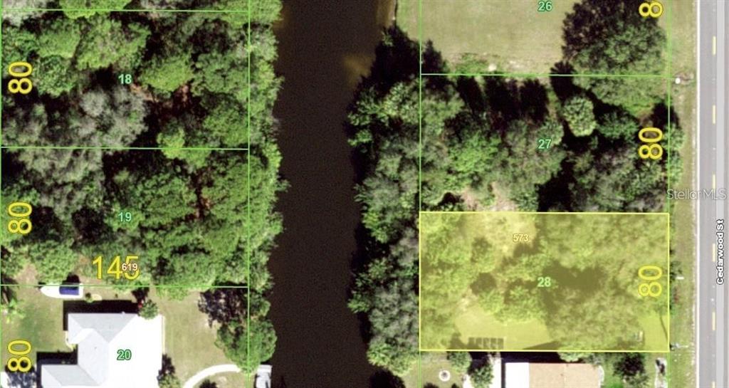 This is an aerial map showing several rectangular land parcels divided by a canal — 2041 CEDARWOOD STREET, PORT CHARLOTTE, FL