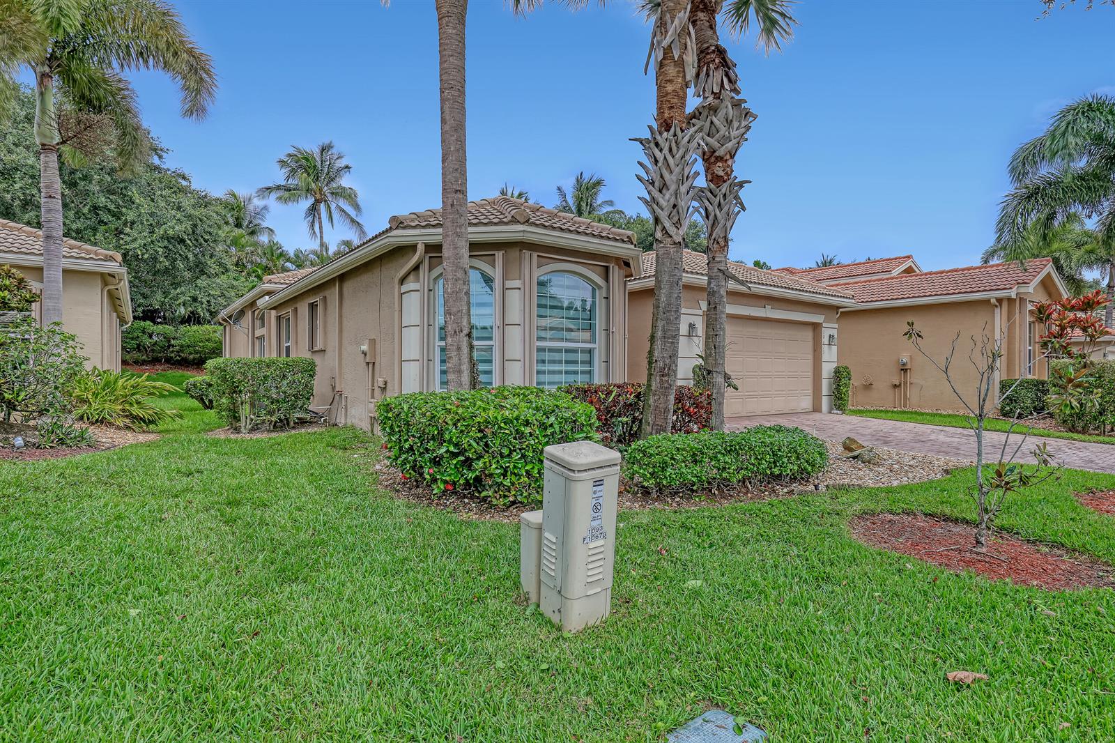 A beige single-story house with a tile roof, a two-car garage, and palm trees — 10673 Richfield Way, Boynton Beach FL 33437, BOYNTON BEACH, FL