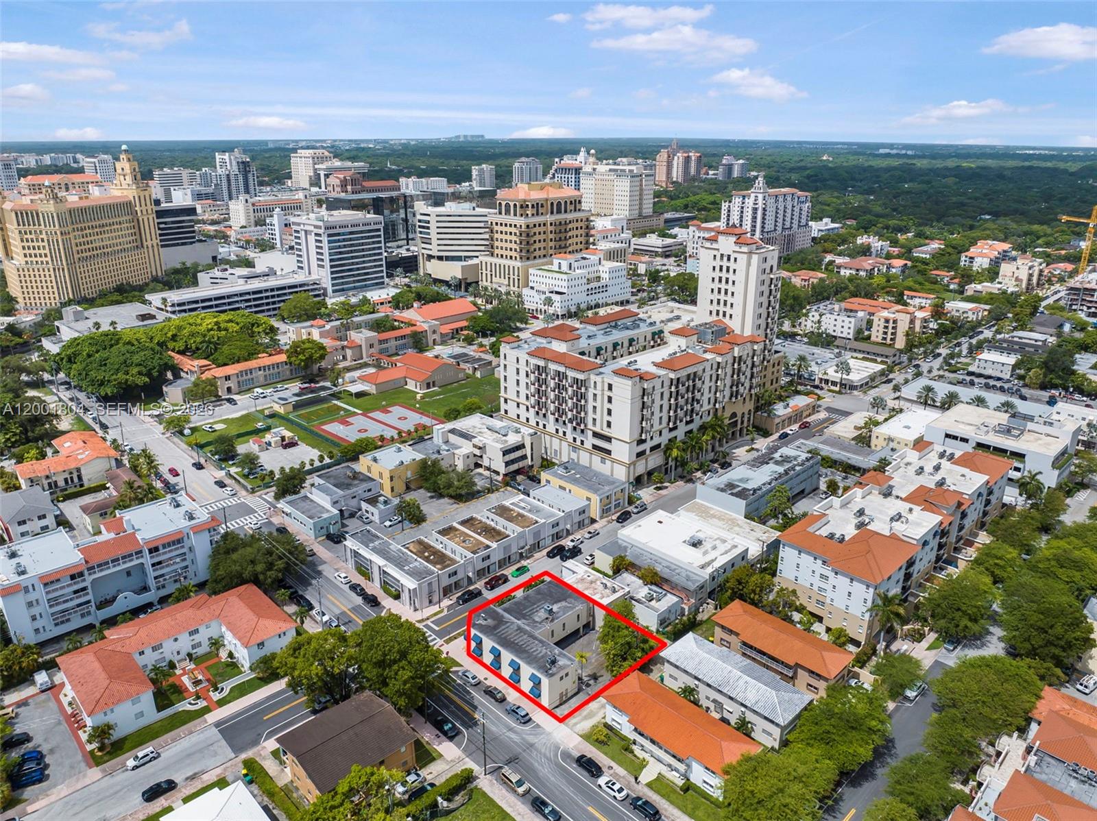 An aerial view shows a two-story commercial building outlined in red within a city neighborhood — 101 Madeira Ave, Coral Gables FL 33134, CORAL GABLES, FL