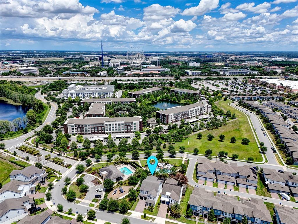 This aerial view shows a residential neighborhood with a marked house near a community pool — 6048 BIMINI TWIST LOOP, ORLANDO, FL