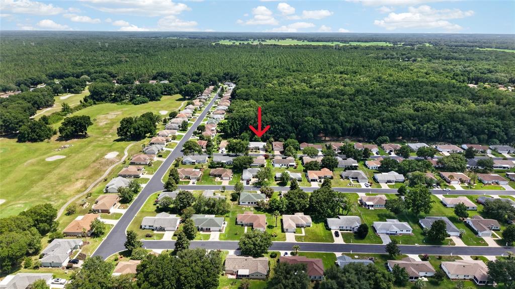 An aerial view shows a residential neighborhood with a red arrow pointing to a house — 11268 SW 139TH PLACE, DUNNELLON, FL