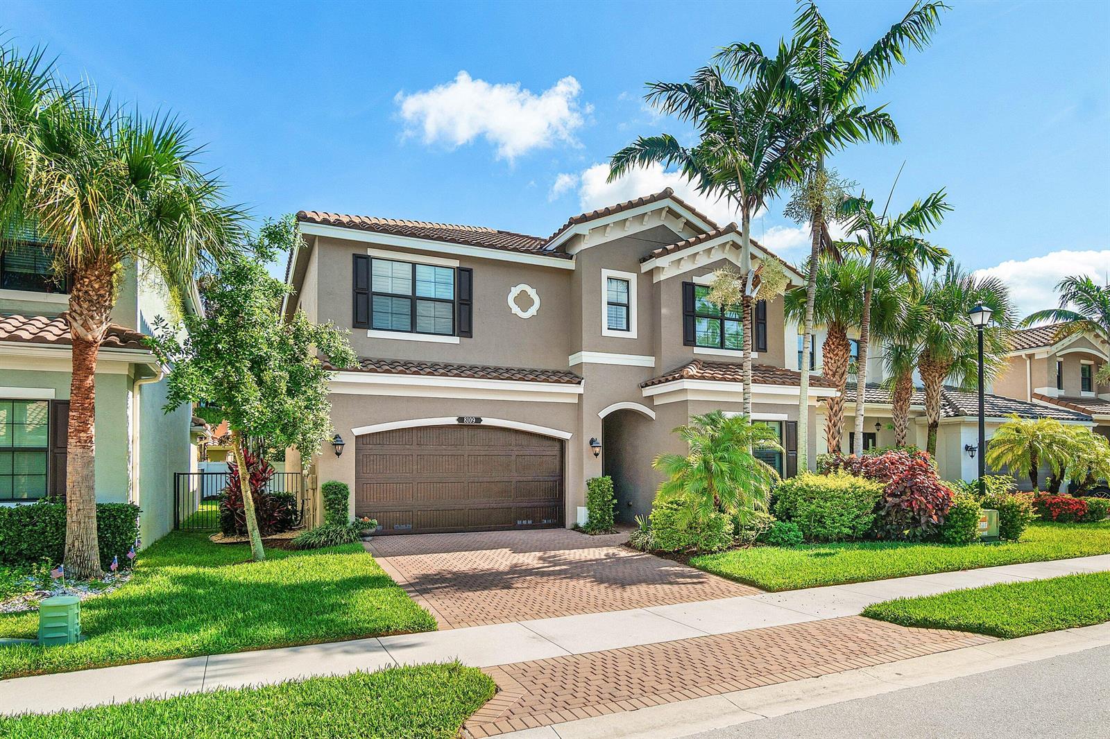 A two-story suburban house with a brown garage, tile roof, and palm trees in front — 8109 Snowflake Obsidian Trail, Delray Beach FL 33446, DELRAY BEACH, FL