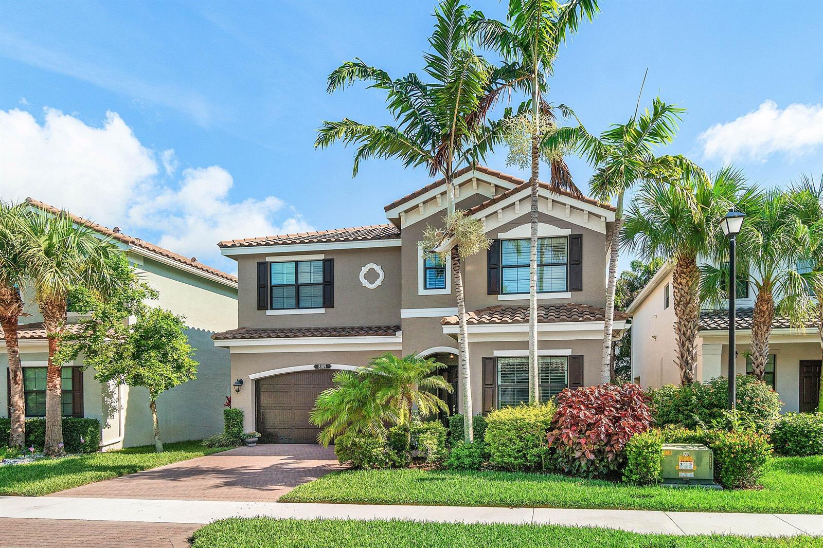 A two-story suburban house with a brown garage, palm trees, and a landscaped front yard — 8109 Snowflake Obsidian Trail, Delray Beach FL 33446, DELRAY BEACH, FL