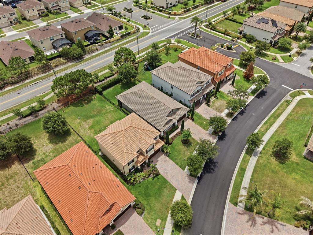 An aerial view shows several suburban houses with tiled roofs and paved driveways — 175 ANCONA AVENUE, DEBARY, FL