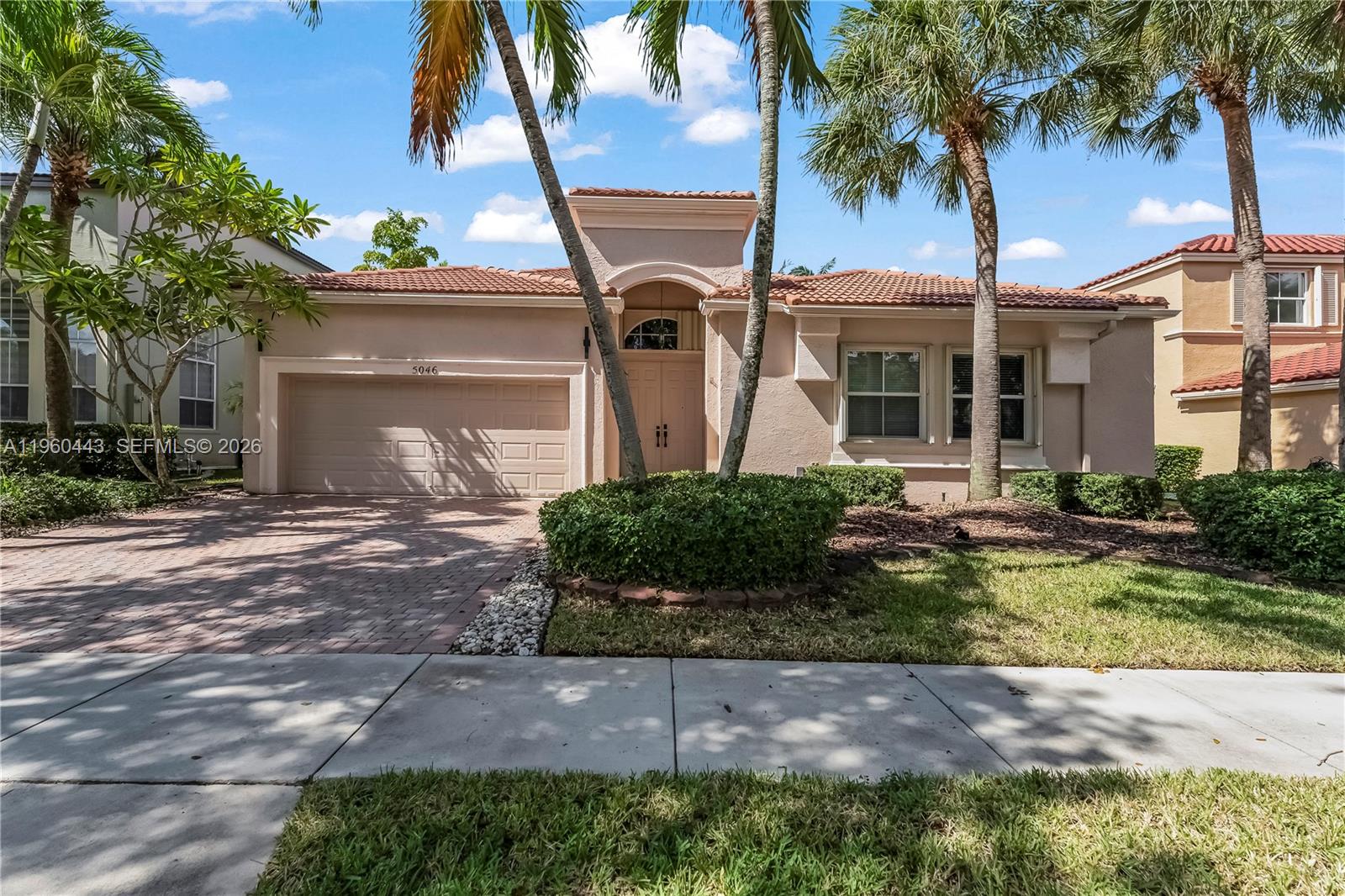 A single-story house with a beige stucco exterior, tile roof, and a paved driveway — 5046 SW 162nd Ave, Miramar FL 33027, MIRAMAR, FL