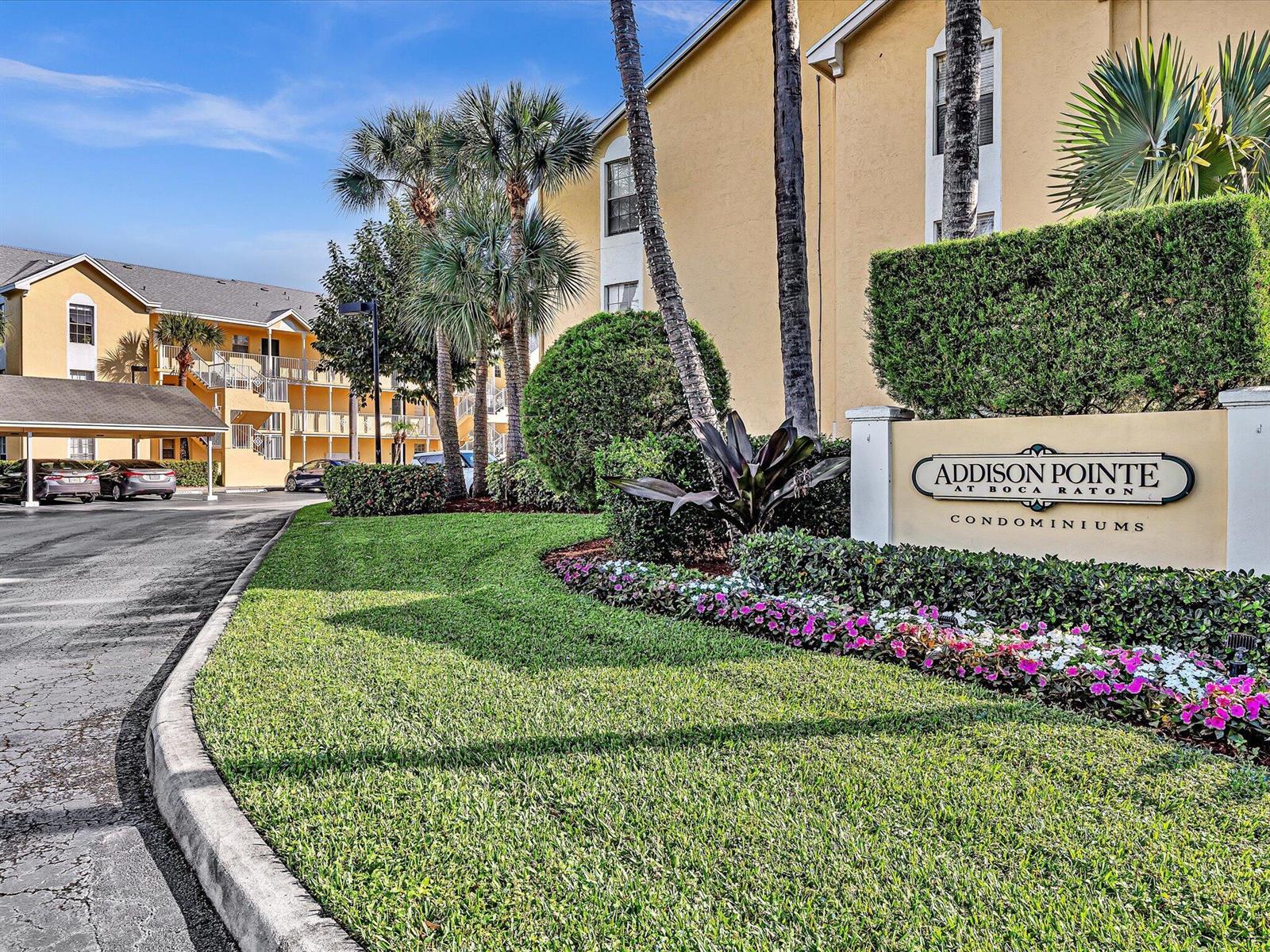 The exterior of the Addison Pointe at Boca Raton condominiums features a landscaped entrance sign — 6284 La Costa Drive # K, Boca Raton FL 33433, BOCA RATON, FL