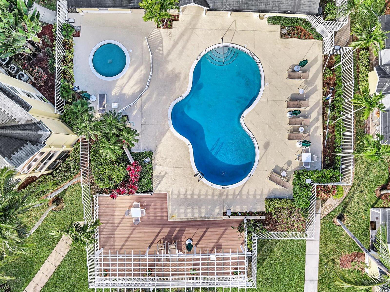 An aerial view shows a swimming pool, a circular spa, and a wooden deck area — 6284 La Costa Drive # K, Boca Raton FL 33433, BOCA RATON, FL