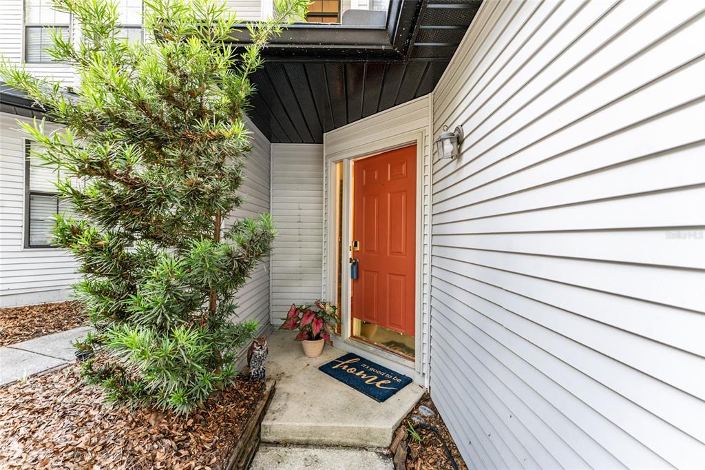 An exterior view shows a front entrance with a red door and a small porch — 831 NW 42ND TERRACE, GAINESVILLE, FL