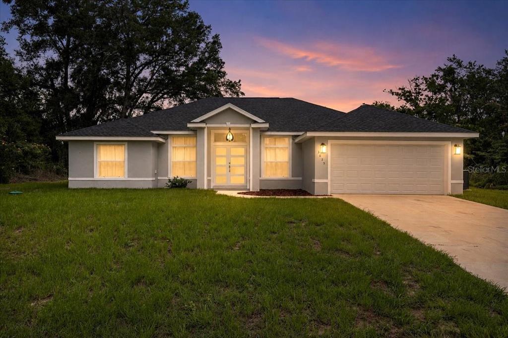 A single-story house with a gray exterior, a two-car garage, and a front entryway — 3625 SE 138TH STREET, SUMMERFIELD, FL