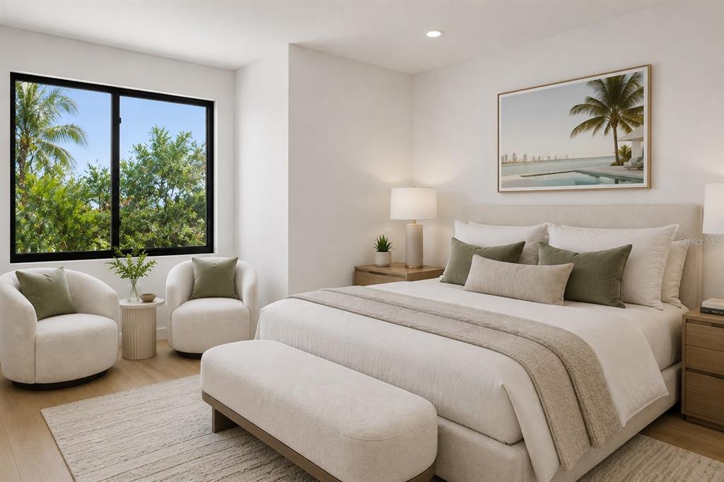A bedroom features a bed, two armchairs, a window with greenery, and neutral decor — 532 W PLAZA PLACE UNIT 3, TAMPA, FL