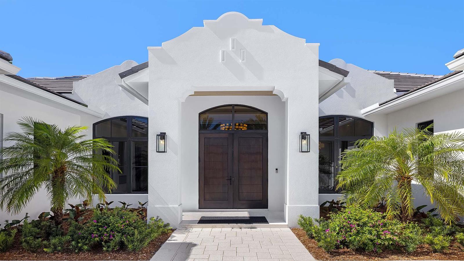 The exterior of a white stucco house features a dark wood double door entrance — 2775 Ave Au Soleil, Gulf Stream FL 33483, GULF STREAM, FL