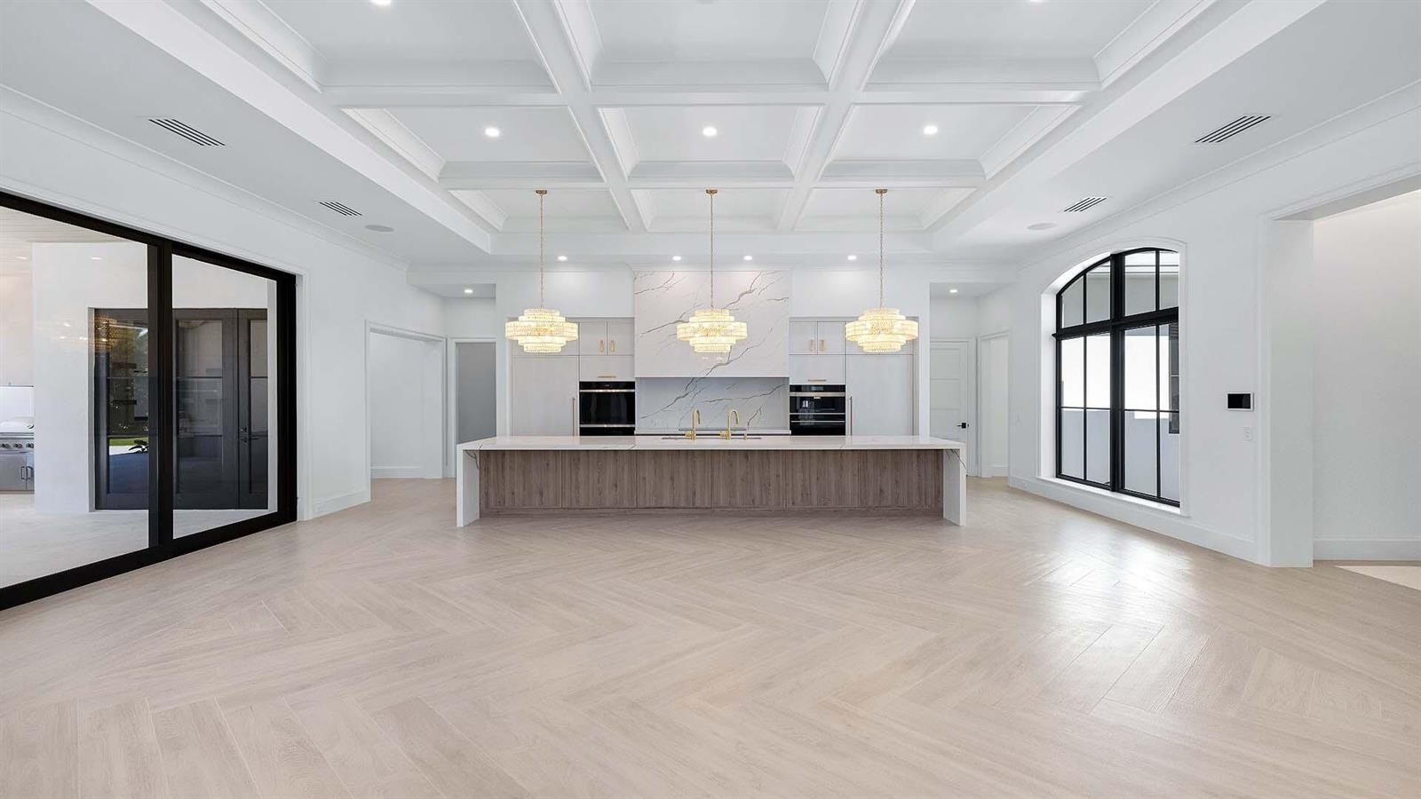 A modern kitchen features a large wooden island, white cabinetry, and a coffered ceiling — 2775 Ave Au Soleil, Gulf Stream FL 33483, GULF STREAM, FL