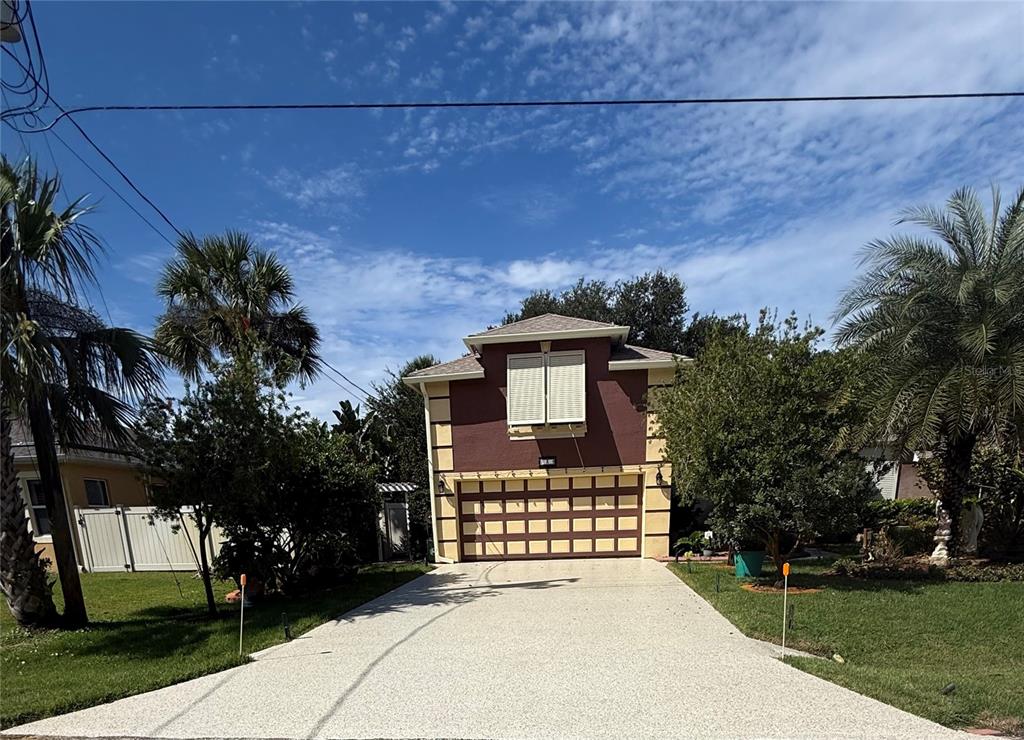 A two-story house with a brown exterior, a large garage, and a paved driveway — 3 SEA BOARD COURT, PALM COAST, FL