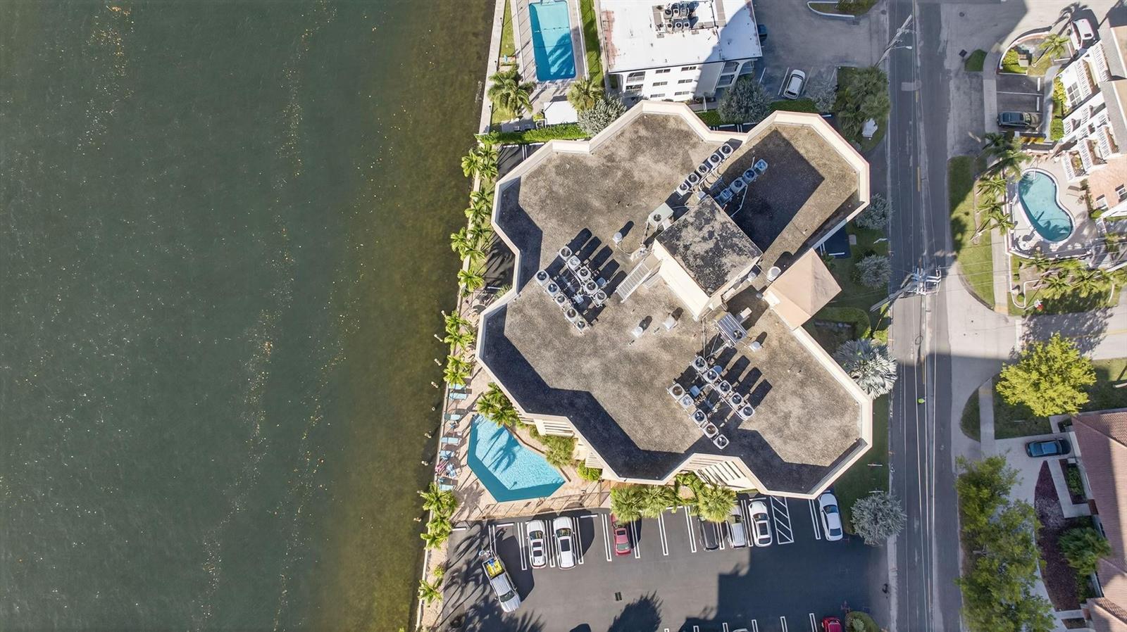 An aerial view shows a multi-story building with a flat roof, pool, and parking lot — 501 N Riverside Drive # 301, Pompano Beach FL 33062, POMPANO BEACH, FL