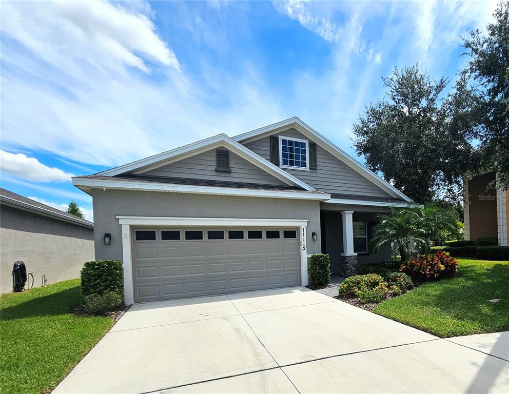 A one-story suburban house with a gray exterior, a two-car garage, and a concrete driveway — 11112 SWANSEA STREET, RIVERVIEW, FL