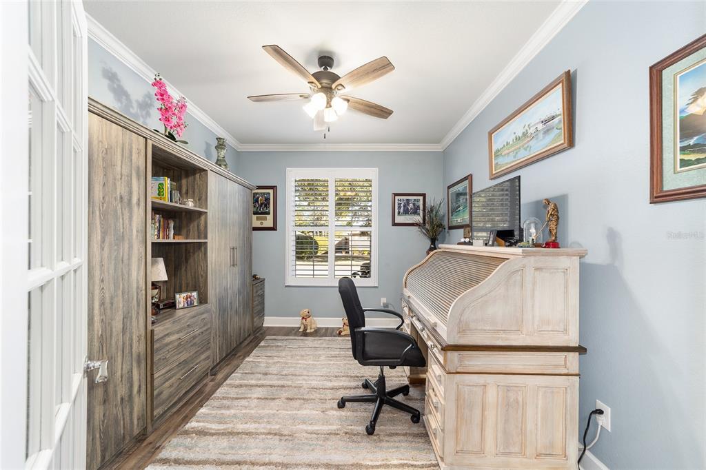 A home office features a roll-top desk, a large storage unit, and a ceiling fan — 6612 SW 91ST CIRCLE, OCALA, FL