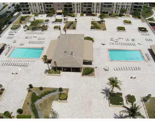 An aerial view of a large residential pool deck with two swimming pools and landscaping — 1201 S Ocean Dr # 2404S, Hollywood FL 33019, HOLLYWOOD, FL