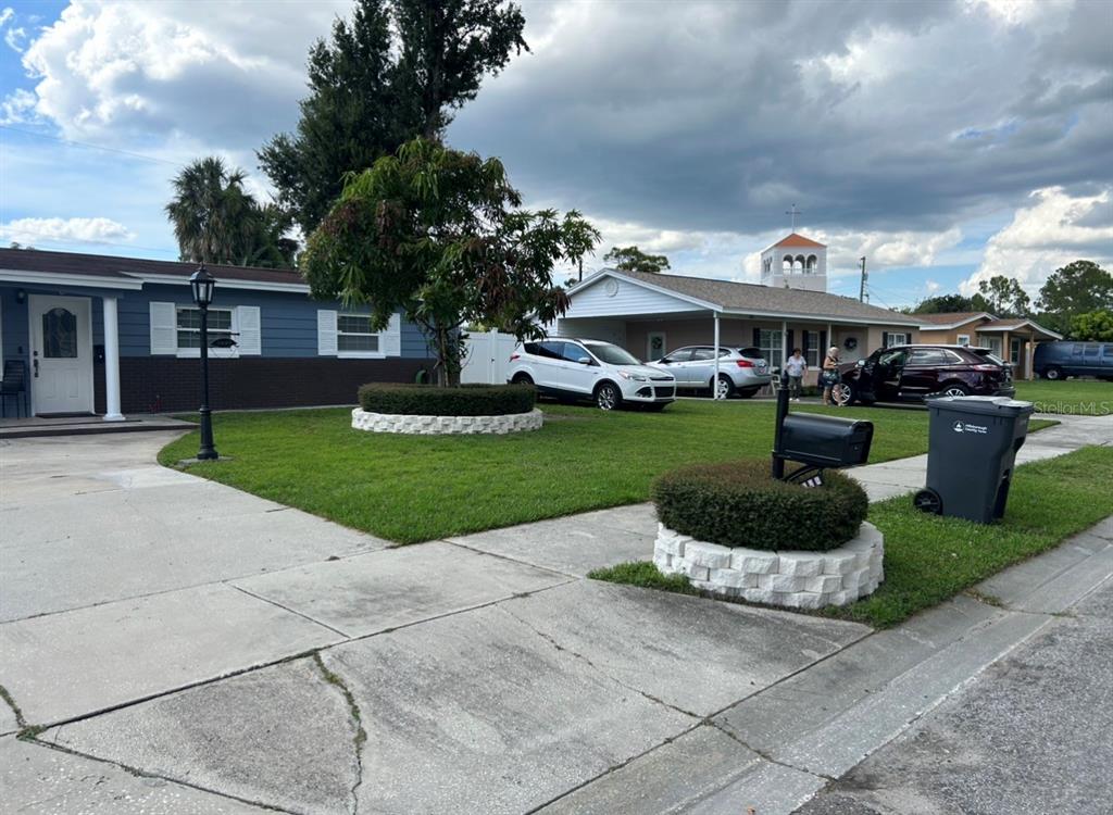 A residential street view shows two single-story houses with lawns, driveways, and parked vehicles — 5112 GATEWAY DRIVE, TAMPA, FL