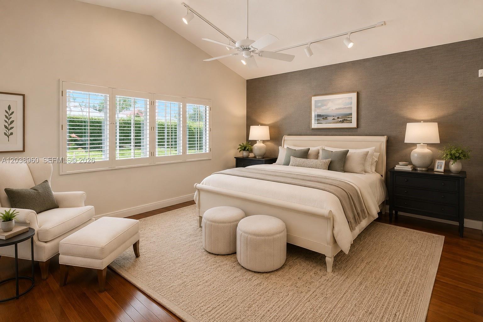 A bedroom features a white bed, two ottomans, a chair with ottoman, and track lighting — 13025 SW 108th Ave, Miami FL 33176, MIAMI, FL